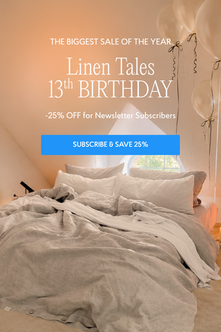 A styled bedroom scene with a bed made up in soft neutral linens, overlaid with promotional text reading 'The Biggest Sale of the Year, Linen Tales 13th Birthday, -25% Off for Newsletter Subscribers, Subscribe & Save 25%'. 