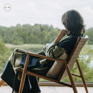 Still Waters Stripe Linen Blend Gown, woman relaxing by a lake-view window - Linen Tales 6